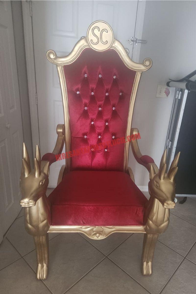 Santa chair photos in Port St. Lucie: gold chair with a red tufted back and reindeer armrests on beige tile.